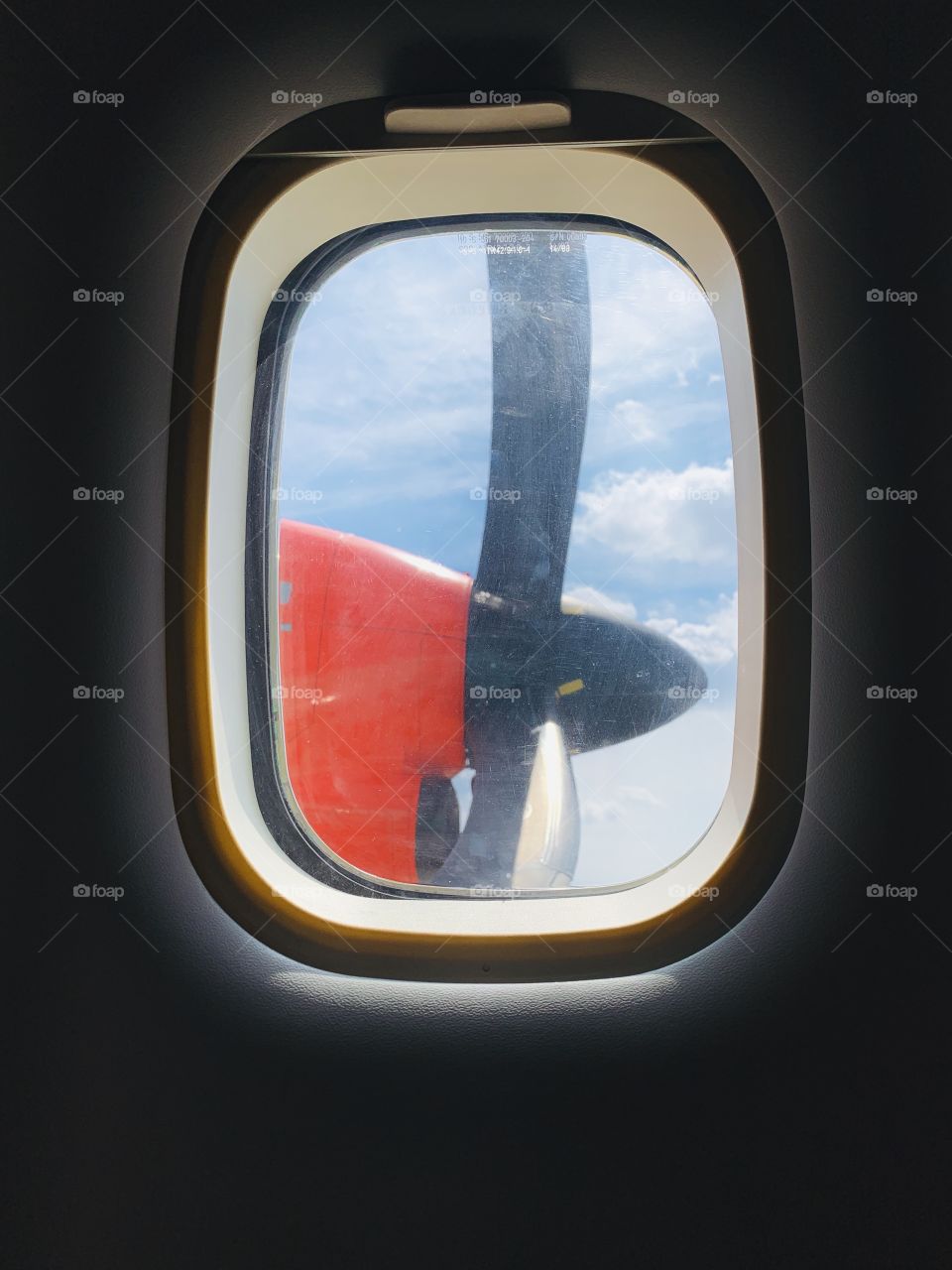 Inside small red aircraft, view from window illuminator 