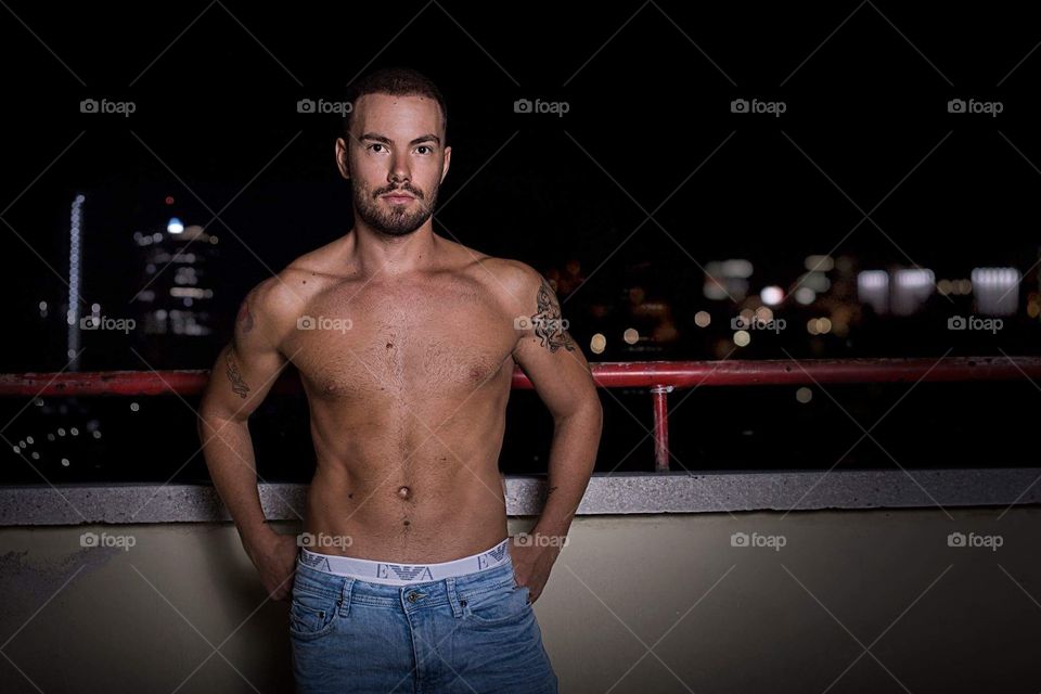 Fashion male model topless at night 