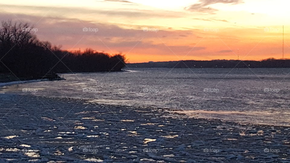sunset over a icy river
