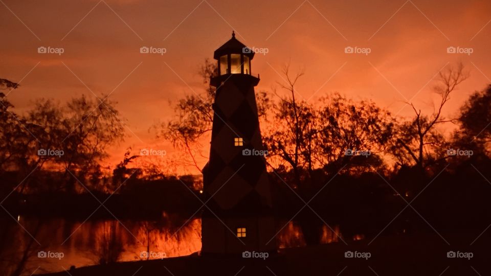 Lighthouse set up in the best spot. Right dab in the middle of this spot to Absorb the brightest spots. Super Orange Glow intense with reflections of Landscape Lakebed on Lake Water.