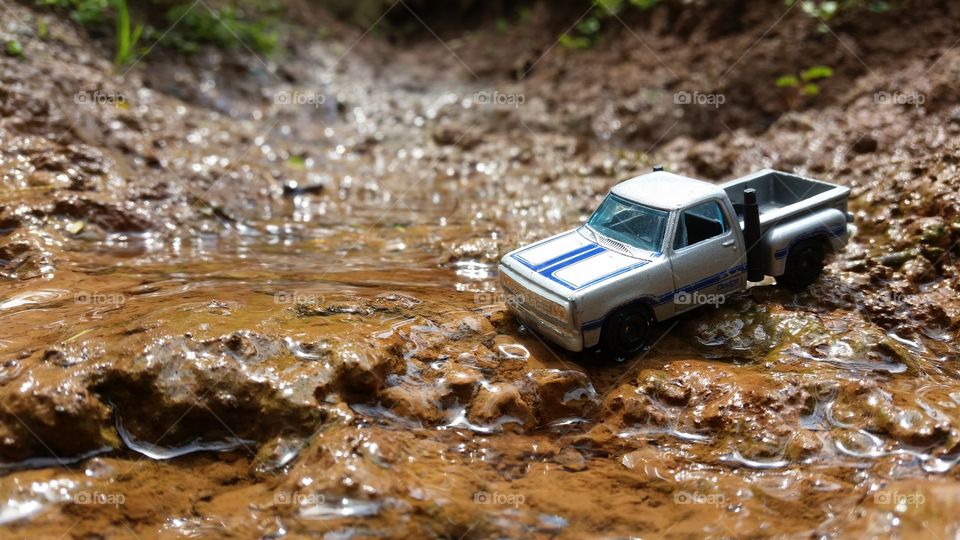 photo of miniature car crossing the river