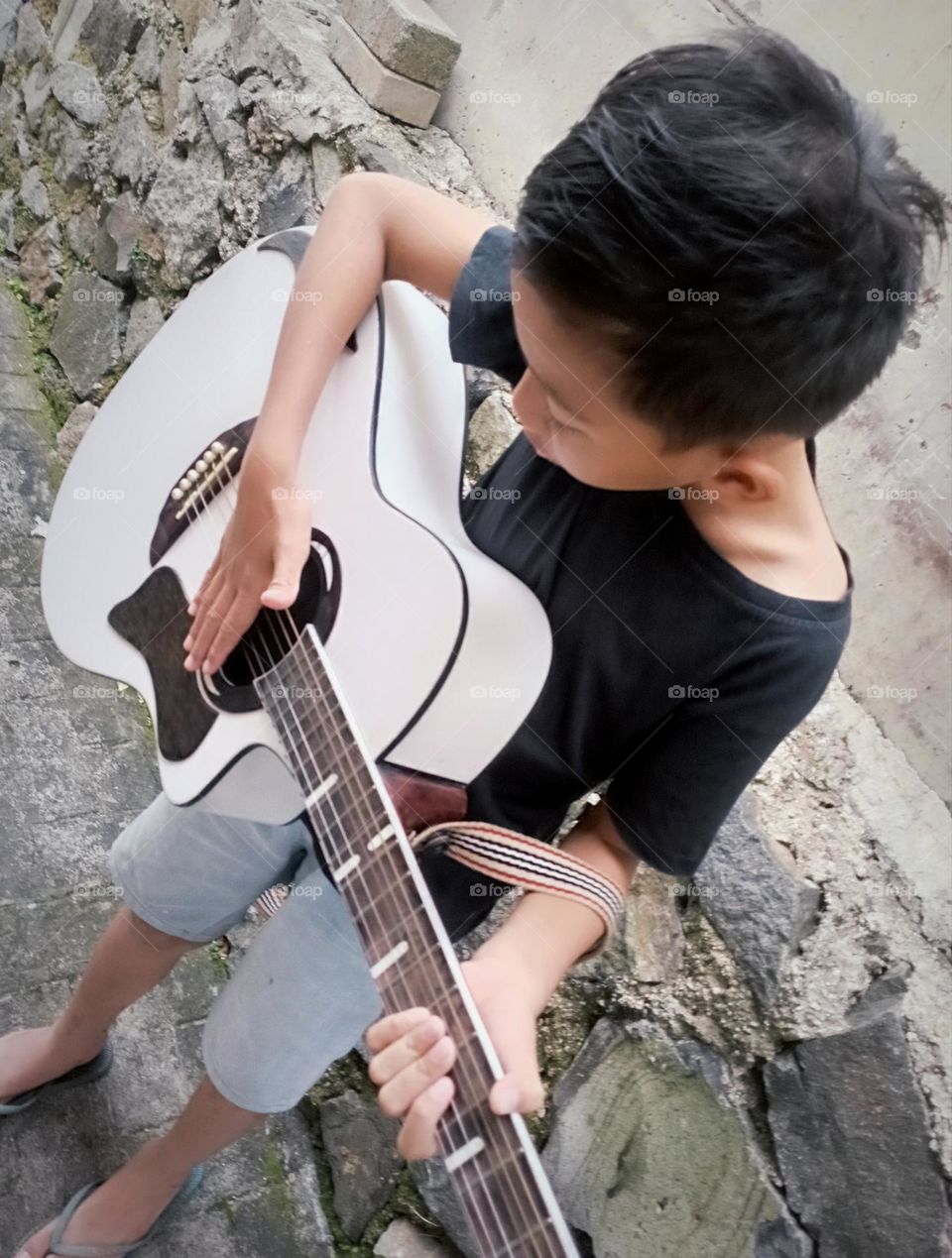 A kid playing guitar