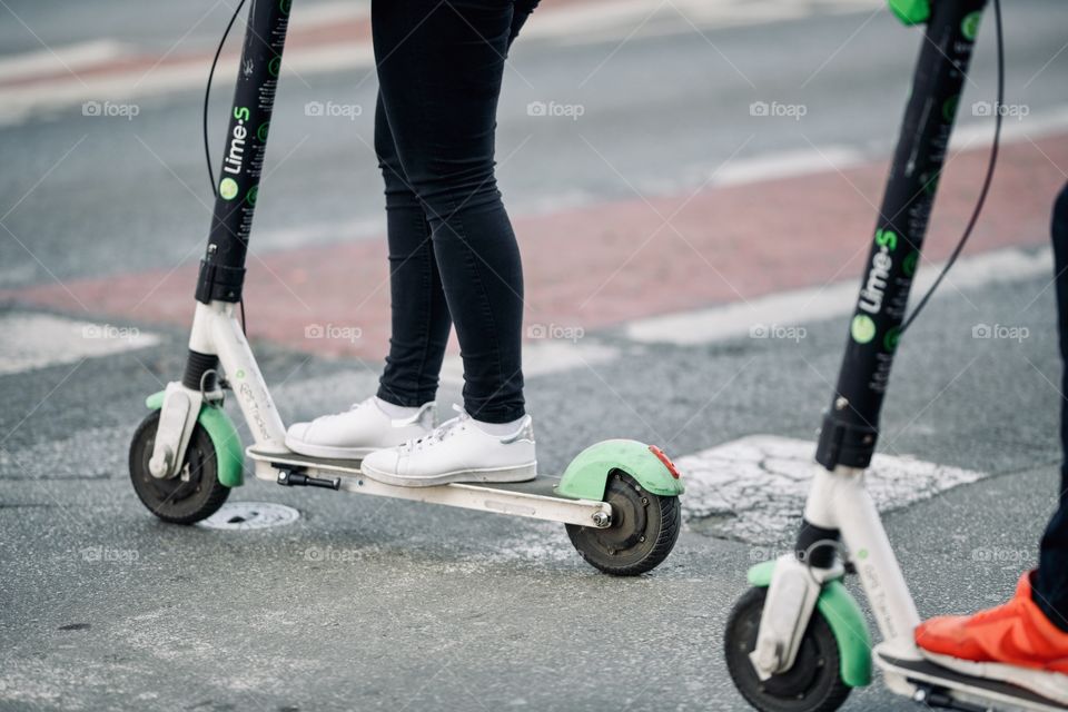 youth moves around the city on scooters