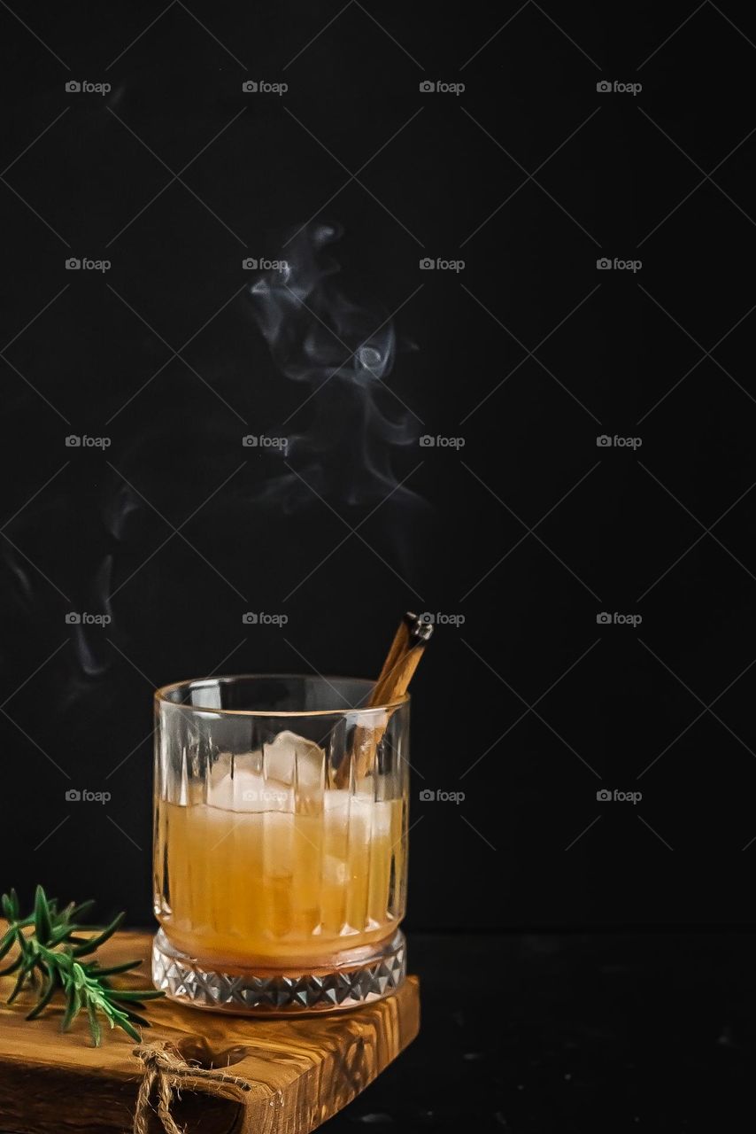 Cinnamon smoking in drink.