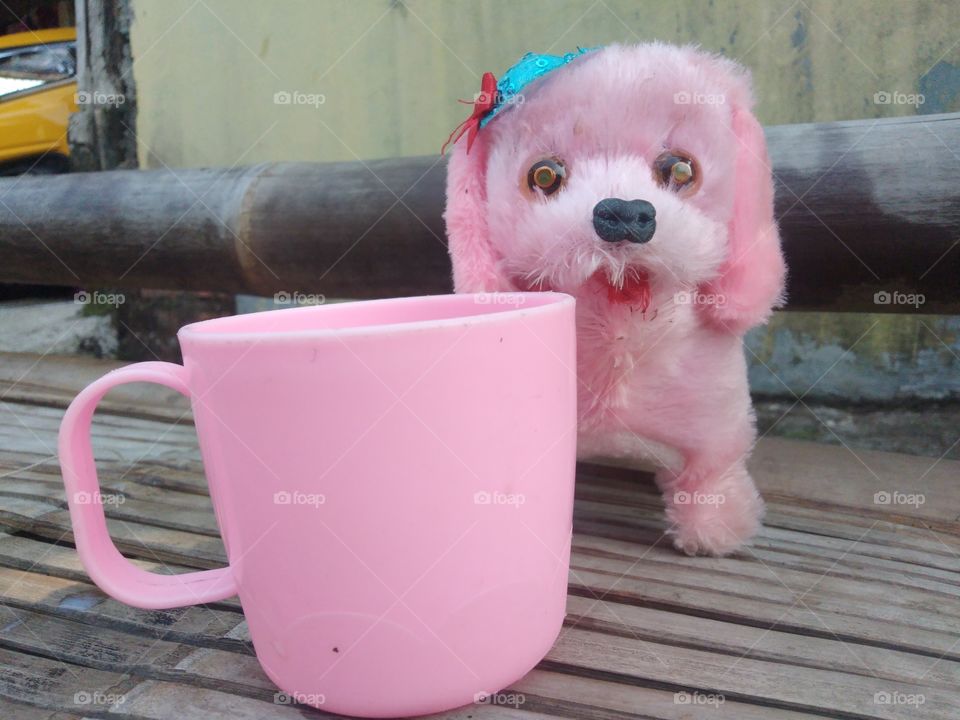 The pink mug and stuffed puppy are so adorable