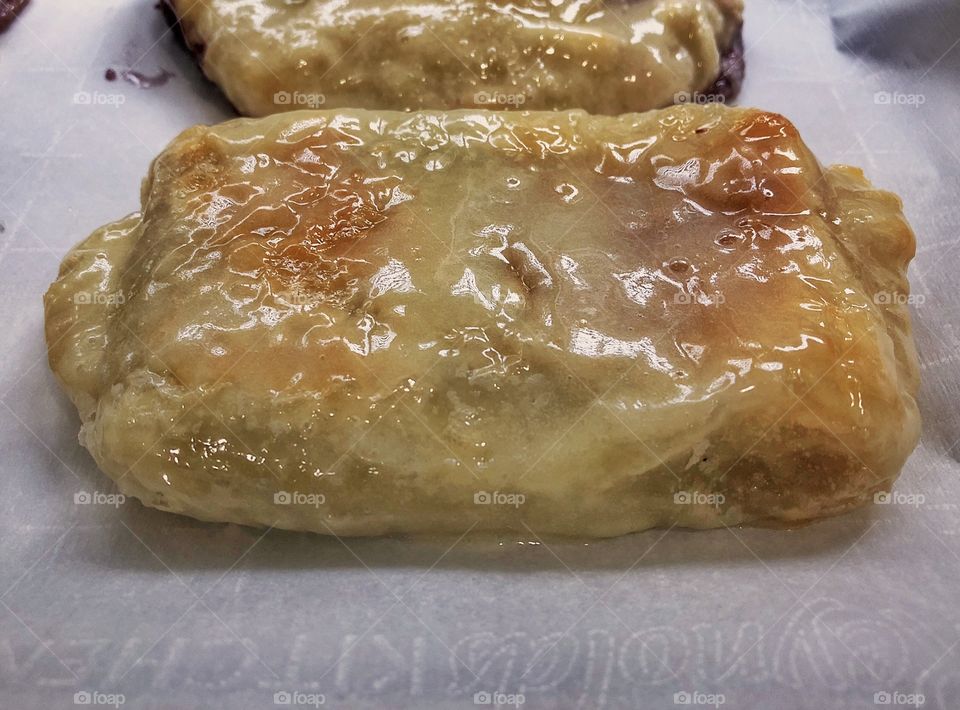 Homemade blueberry and cream cheese puff pastry with heavy glaze