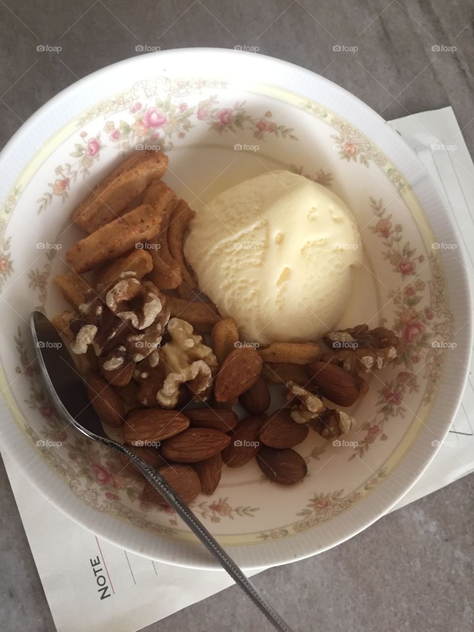 Dessert - vanilla icecream topped with raw almonds, walnuts and honey mustard soy crisps