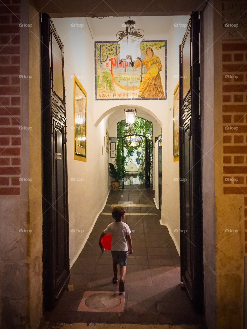 child coming down the hall with a balloon