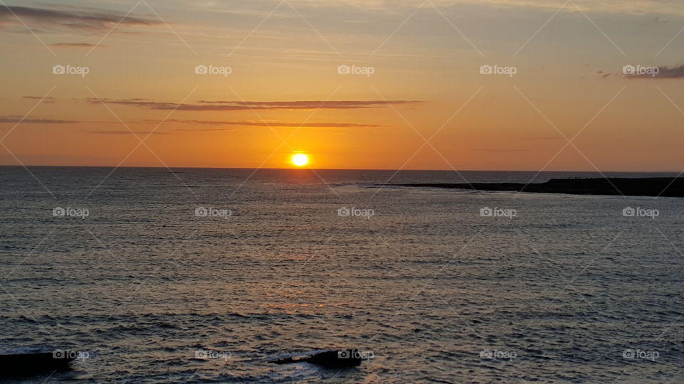 Low sun at sunset over the Atlantic in western Ireland, nice orange sky. Dusk