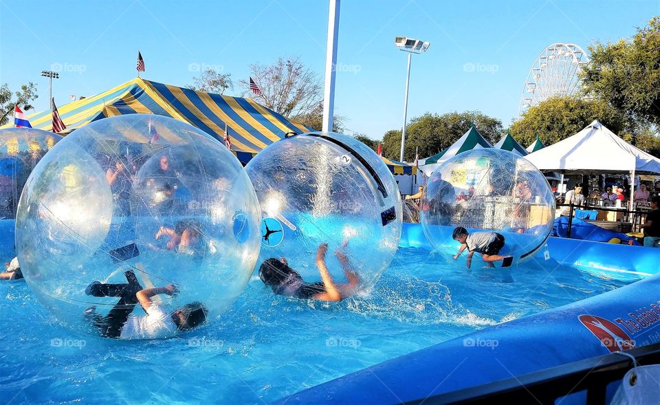 Kids playing inside the water balls