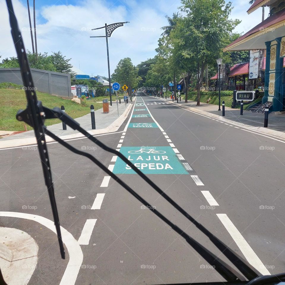 traveling by electric vehicle on empty streets with bicycle lanes on the side