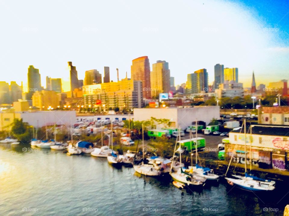 Newtown Creek in Long Island City, Queens, NY and its boats seen from the top of the Pulaski Bridge that connects Greenpoint, Bklyn and LIC. In the distance the Manhattan skyline can also be seen. 2019. Hypnotic Productions