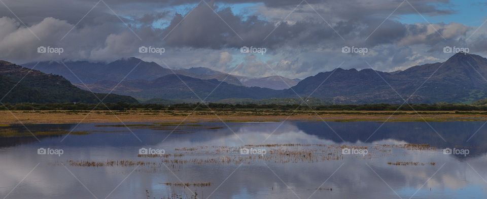 view of the Snowdonia mountain range over water