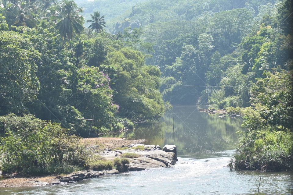 It is a beautiful river calmly flowing through forest and beautiful mountains