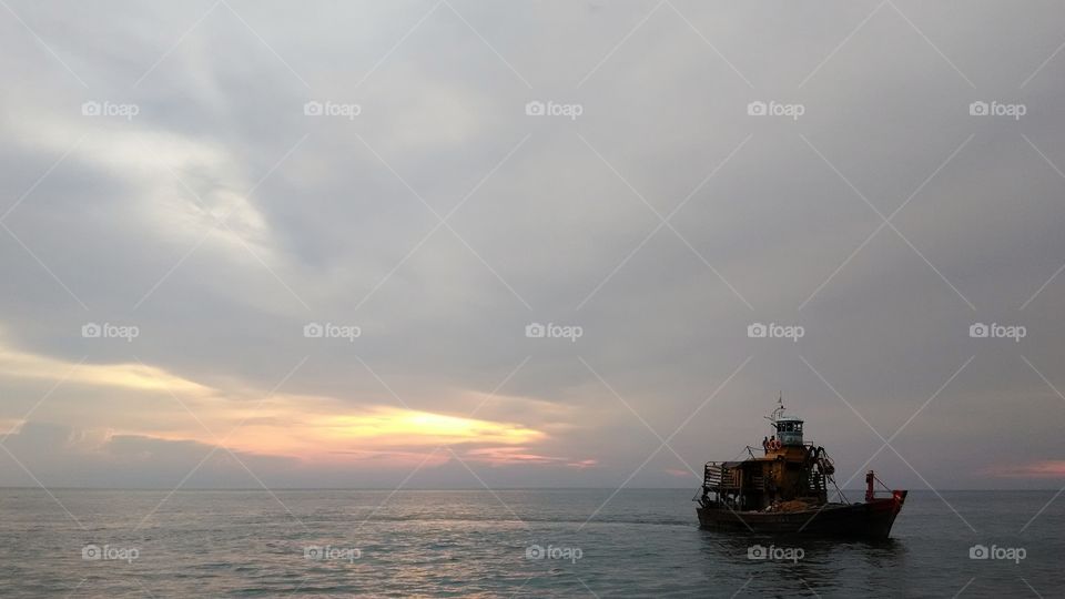 Ship at sea during sunset