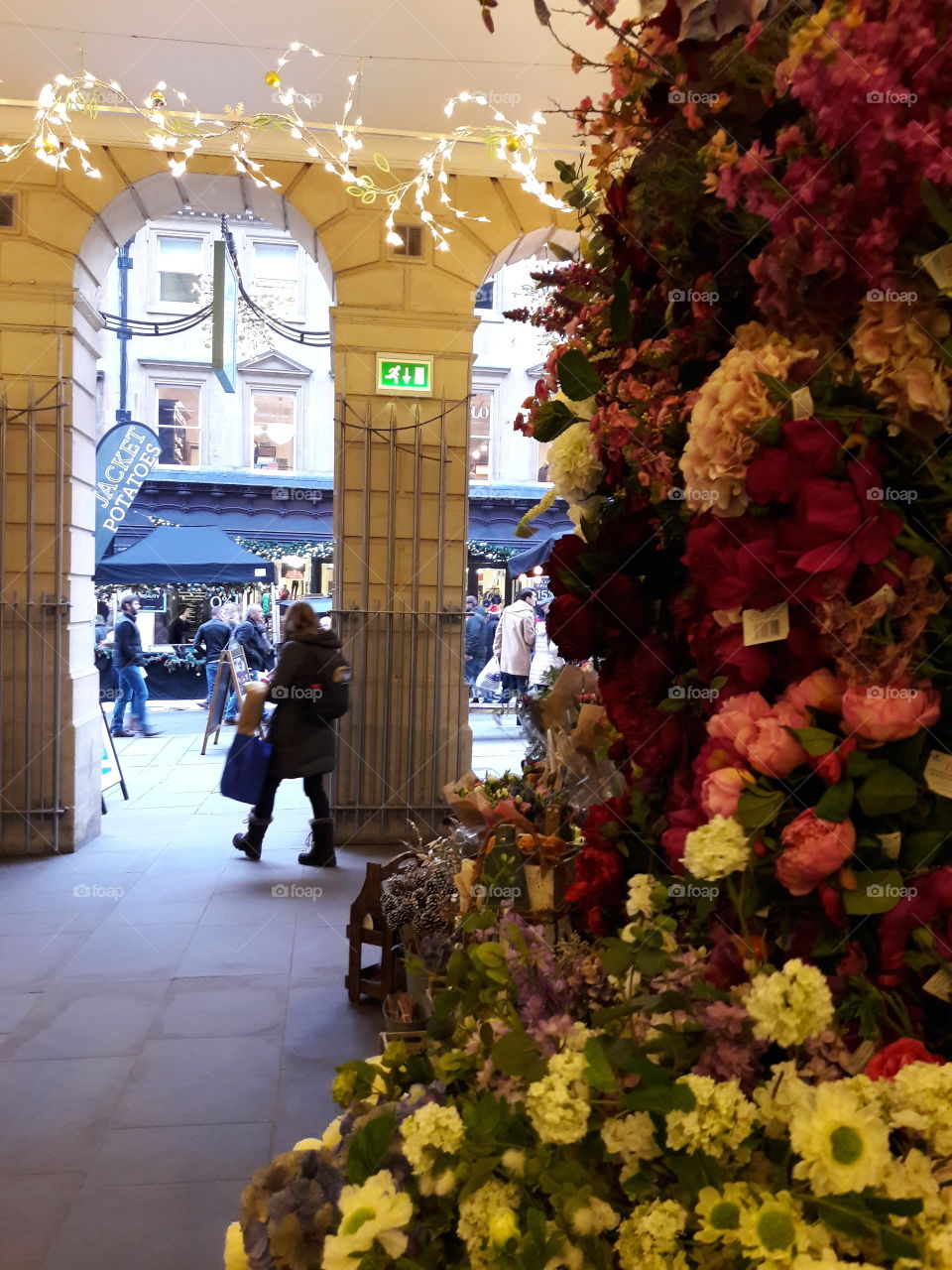 Flowers for sale at a florist in Bath. The high street is in view of the archway