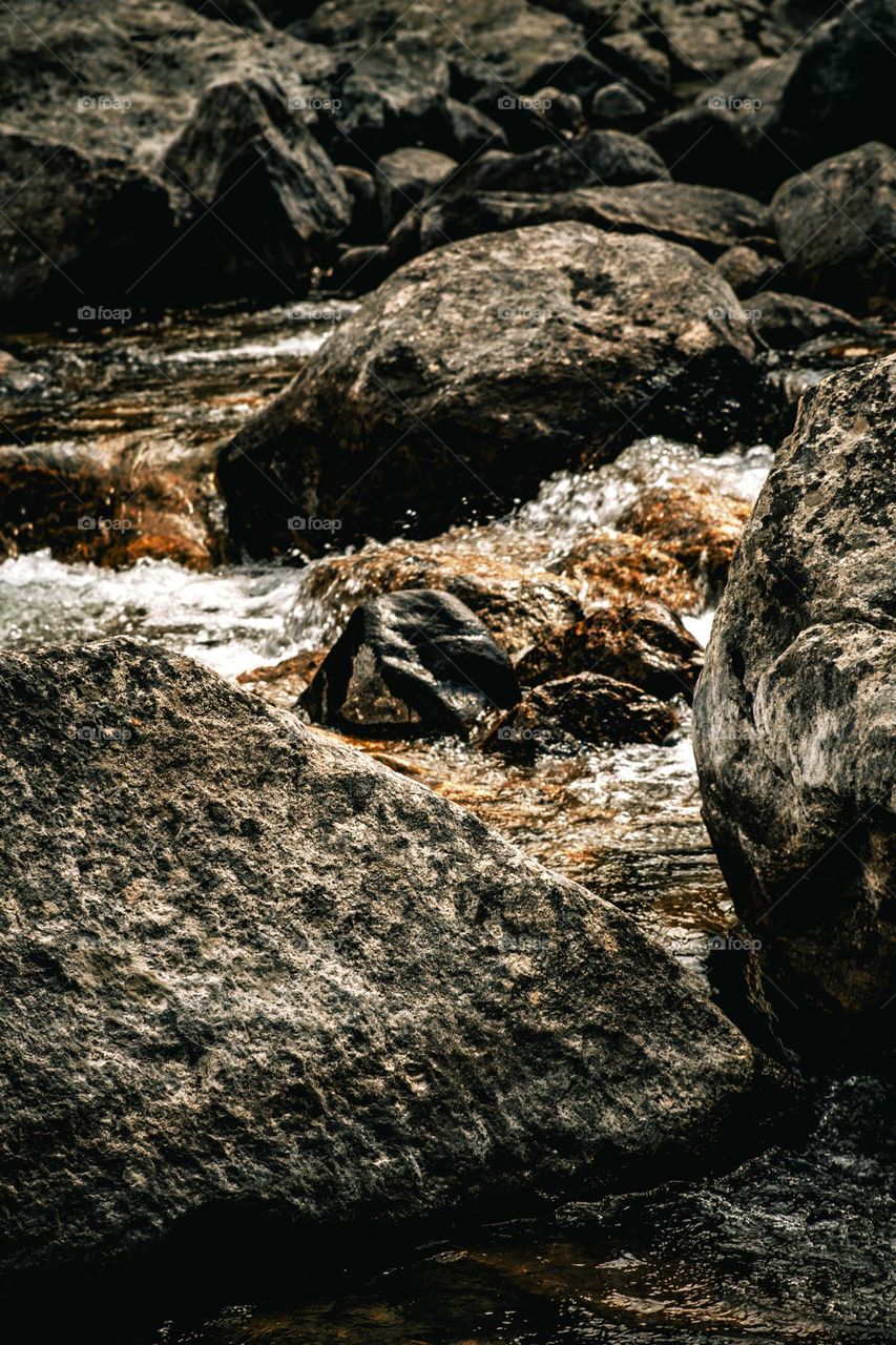 Flowing river and it’s huge boulders.