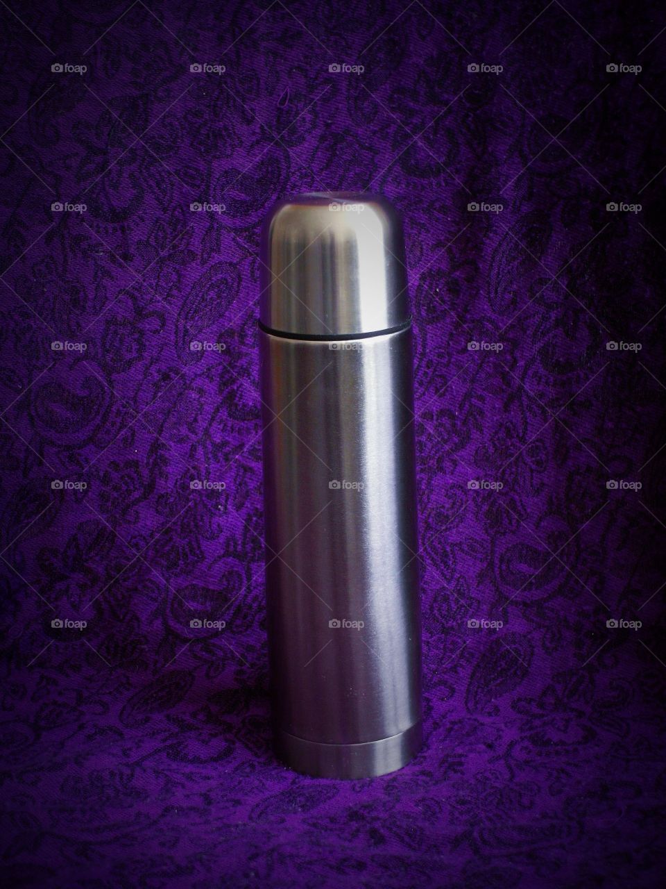 Metal thermos with purple background 