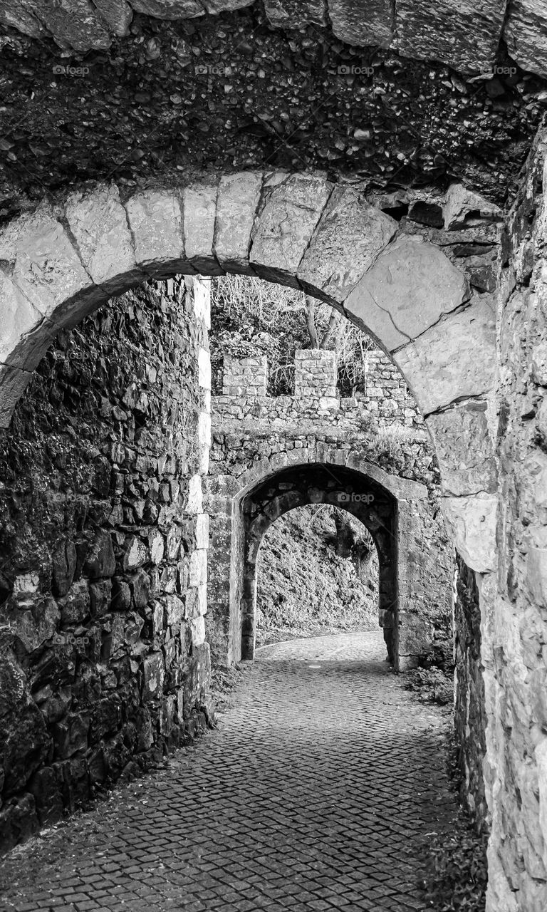 Stone archways that form part of the castle wall in Leiria, Portugal