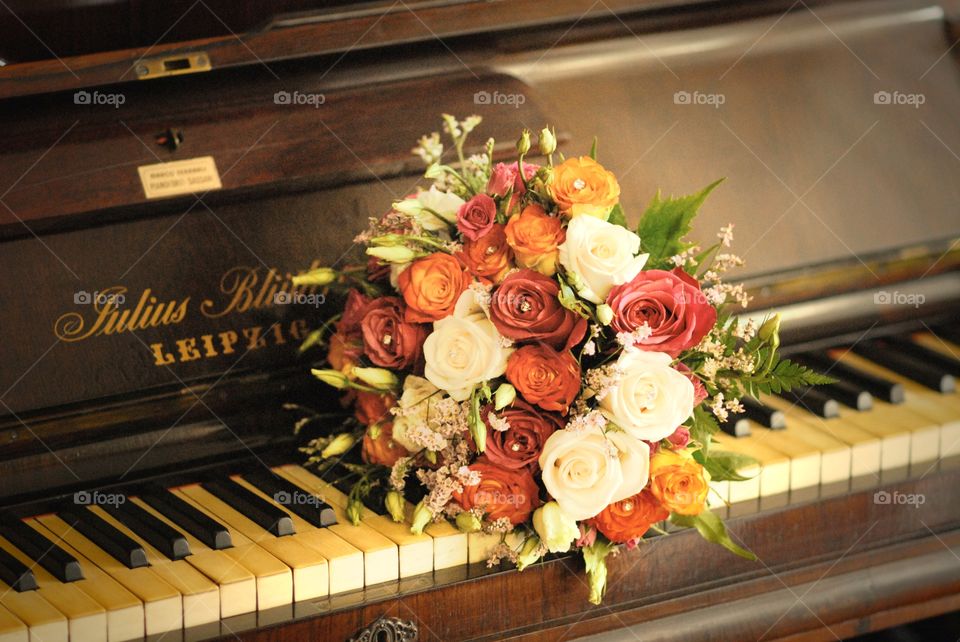 rose wedding bouquet over piano