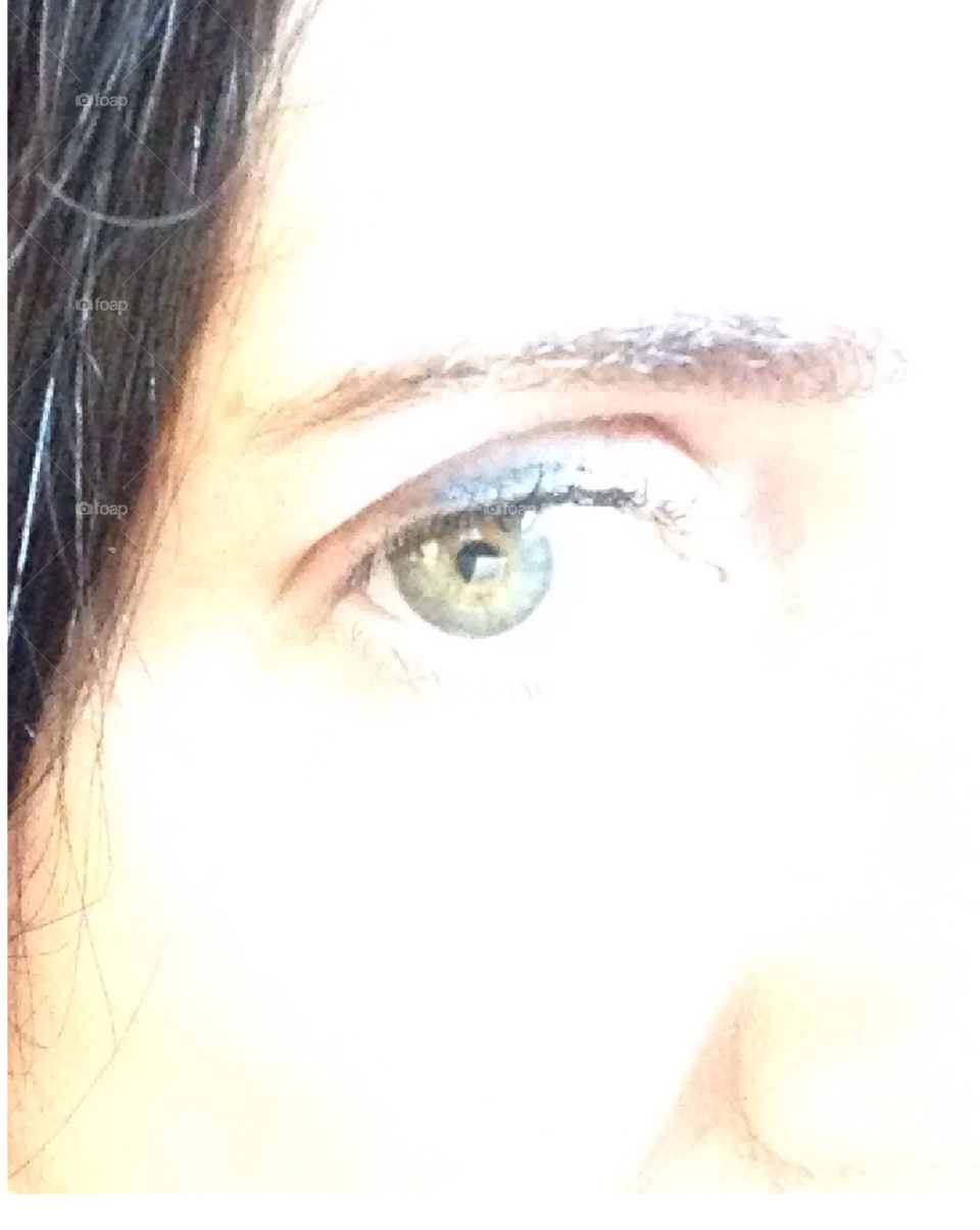 A woman's big beautiful green eye.