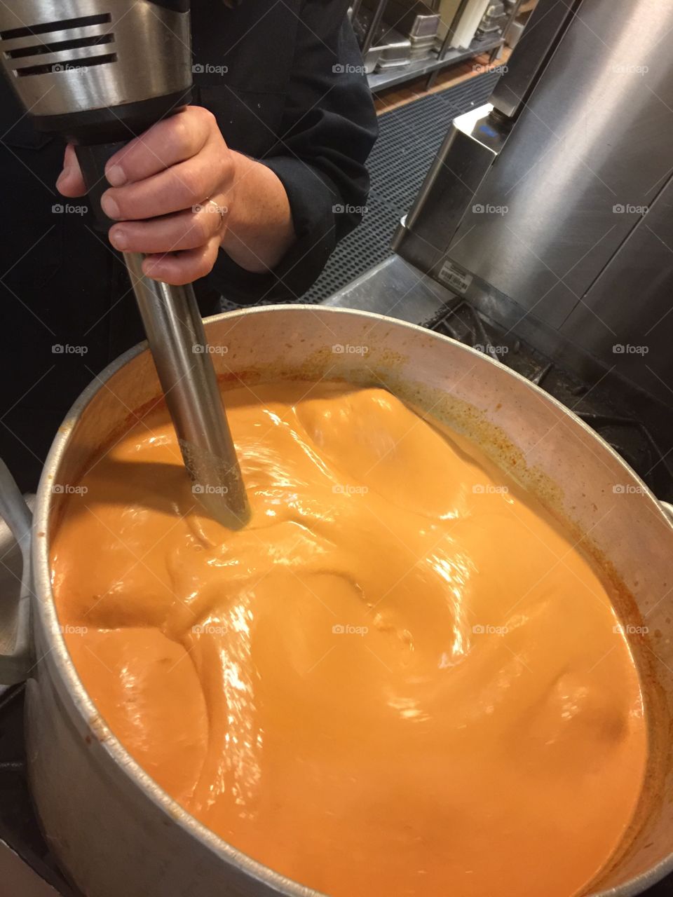 Mixing tomato bisque soup 