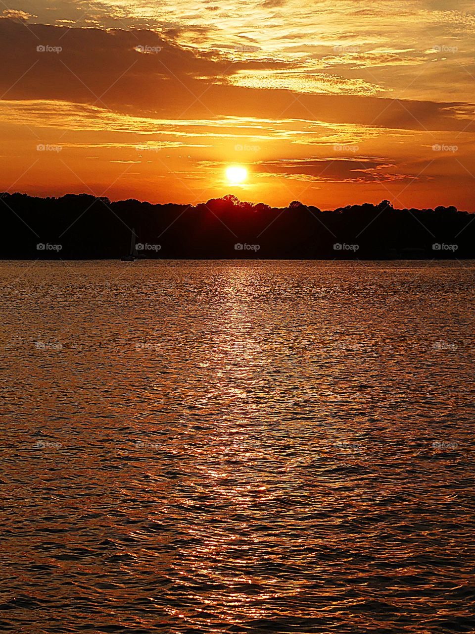 This is the last light of the night as boaters navigate their vessels through the waterway under a magnificent sunset