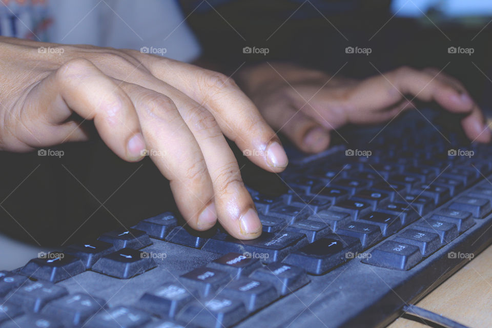 A professional person typing or using an office laptop keyboard. View of a online social media marketing executive network worker working on a desktop computer, business concept