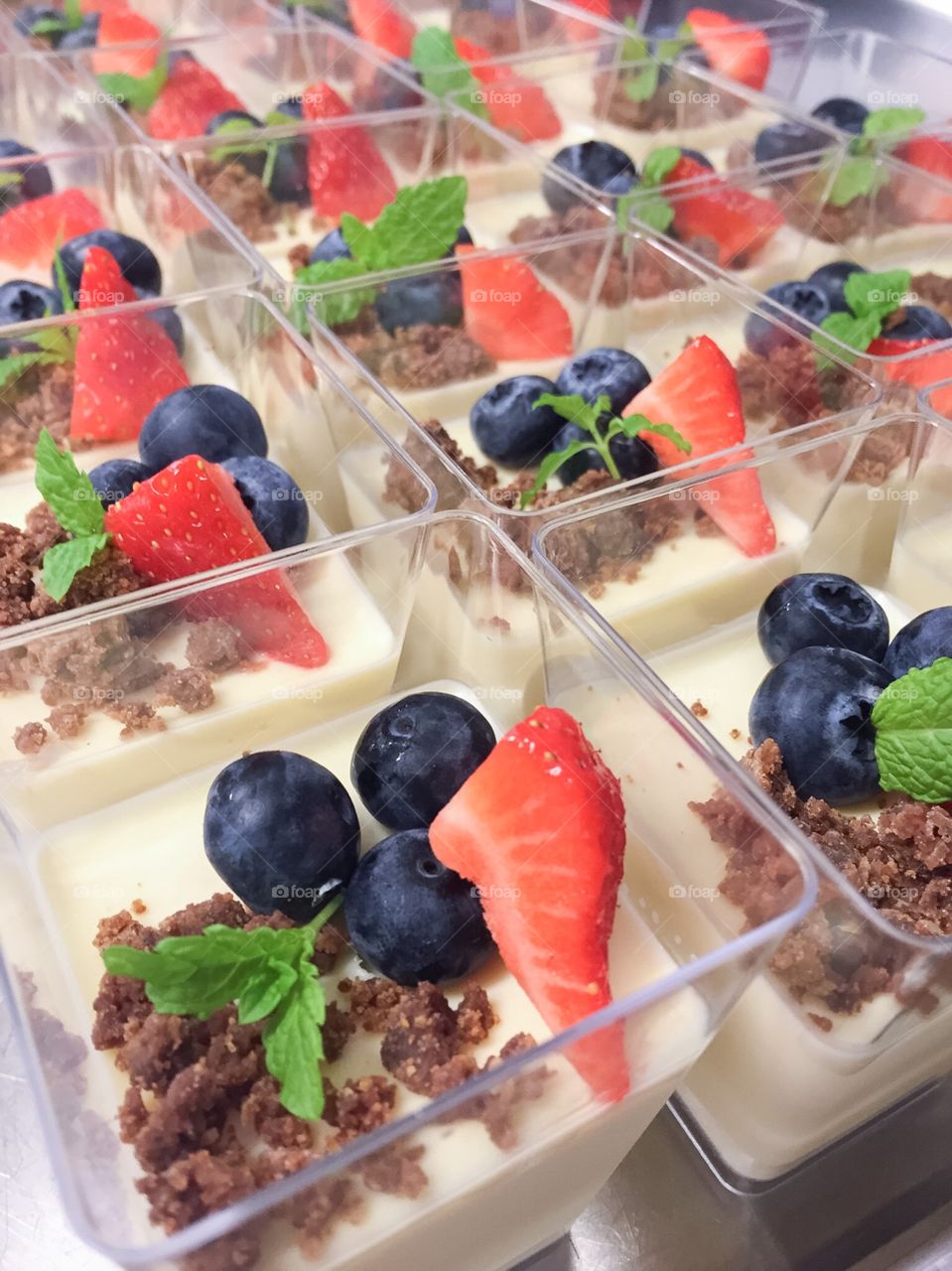 Pannacotta with chocolate, strawberries and blueberries.