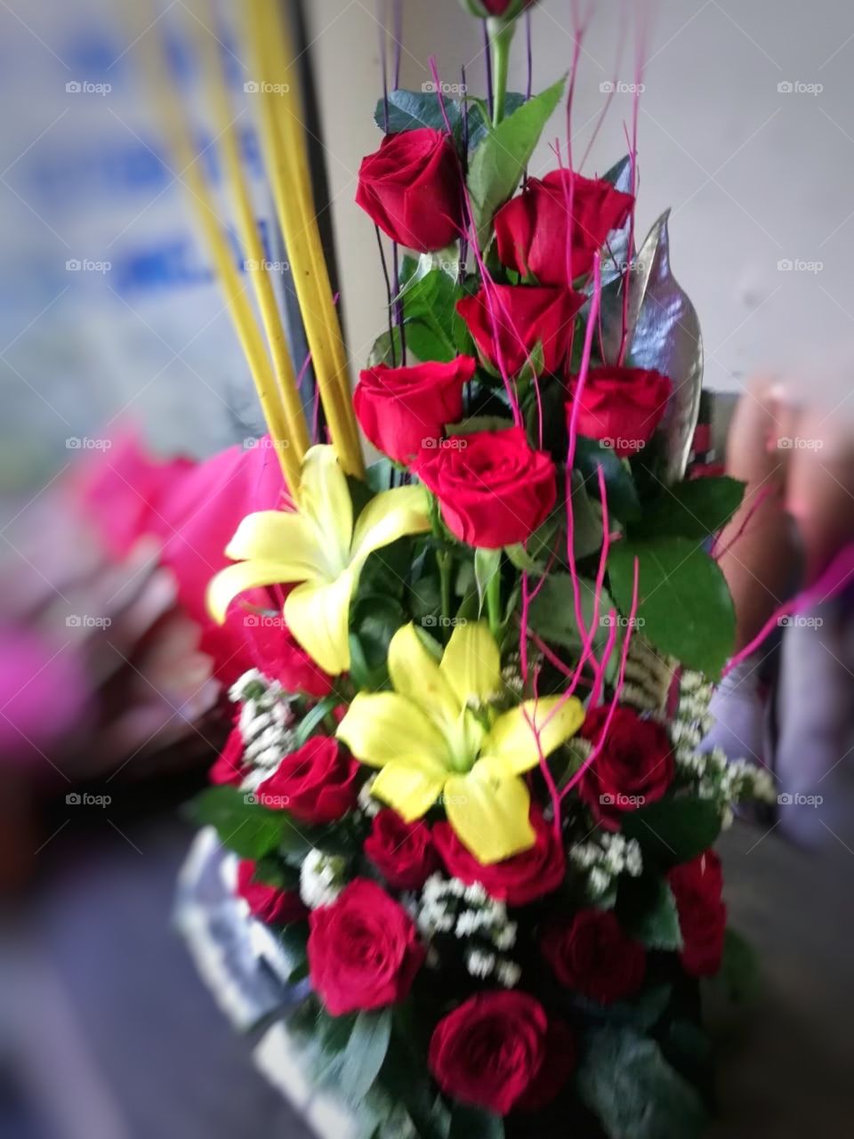In this photo you can see a beautiful Bouquet with some different kinds of flowers and leaf it’s looks so beautiful and colourful