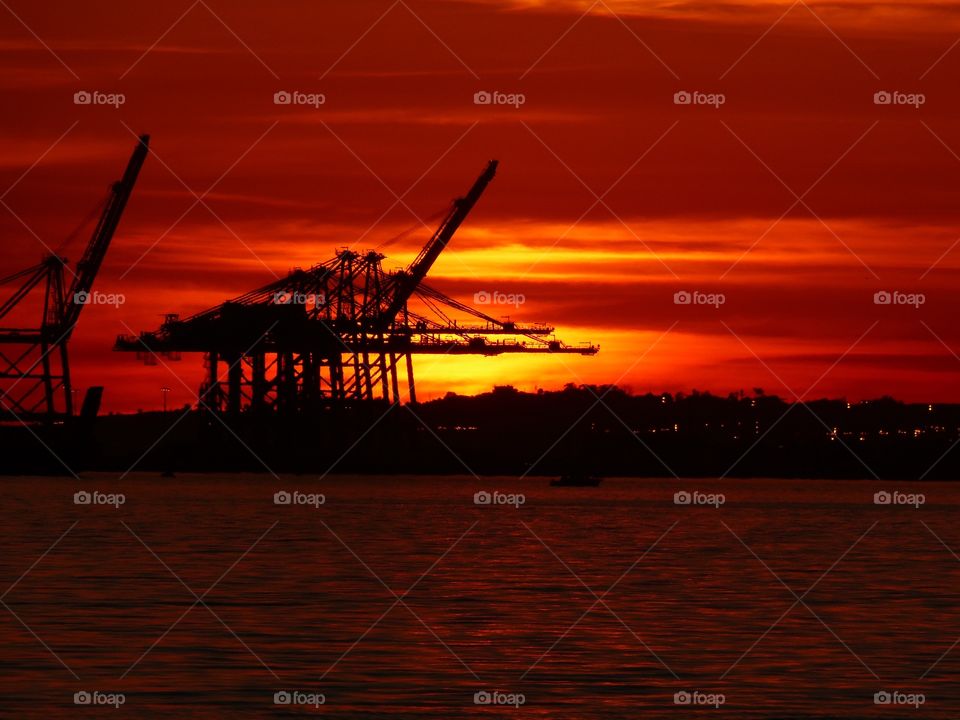 Dramatic orange sunset over harbor 