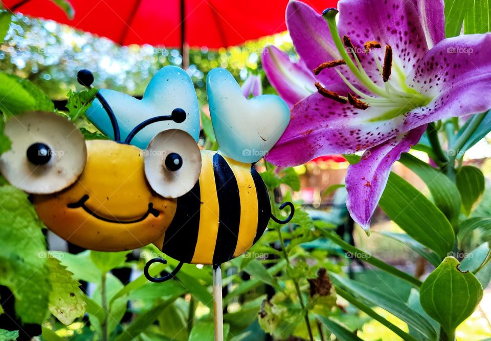 Happy Metal art Bumblebee in summer garden with purple oriental Lily