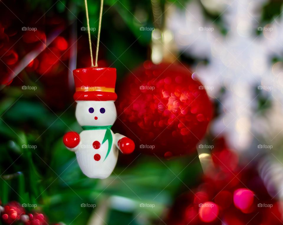Red Christmas decorations on a green tree