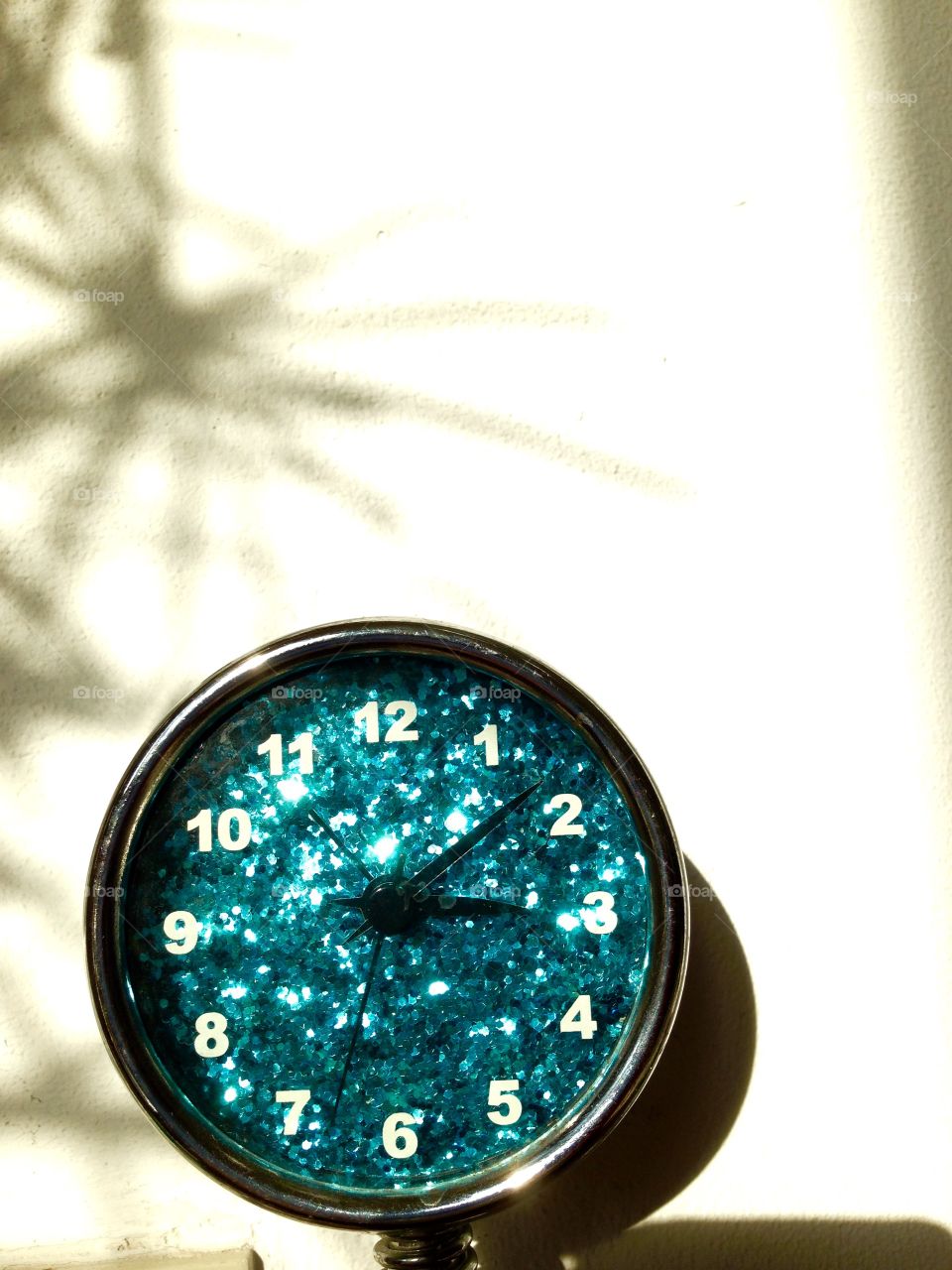 Sparkeling blue clock in the afternoon