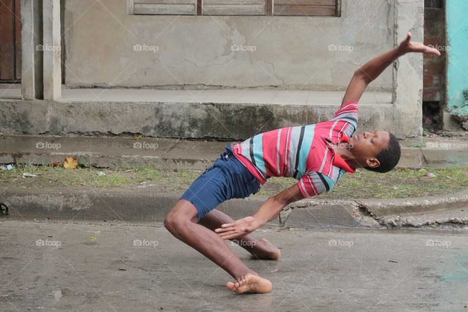 Young boy dancing in the street. Young boy dancing in the street