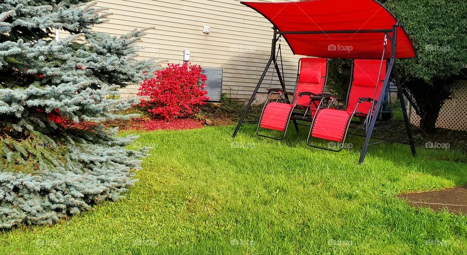 red swinging chair relaxed front yard patio chairs