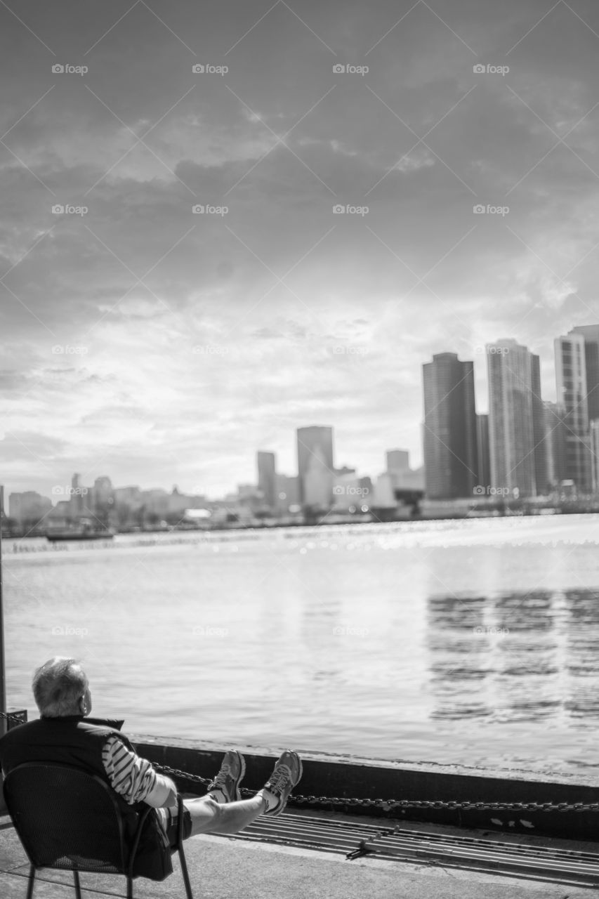 Sunny - stormy day @chicago this gentleman relaxes as the storm is heading our way at Navy Pier. 