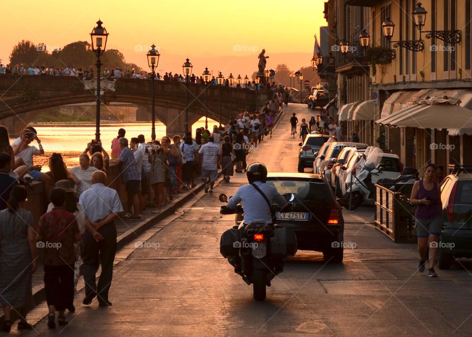 A Man in Casual Business Clothes Rides Motorcycle on City Road, Florence