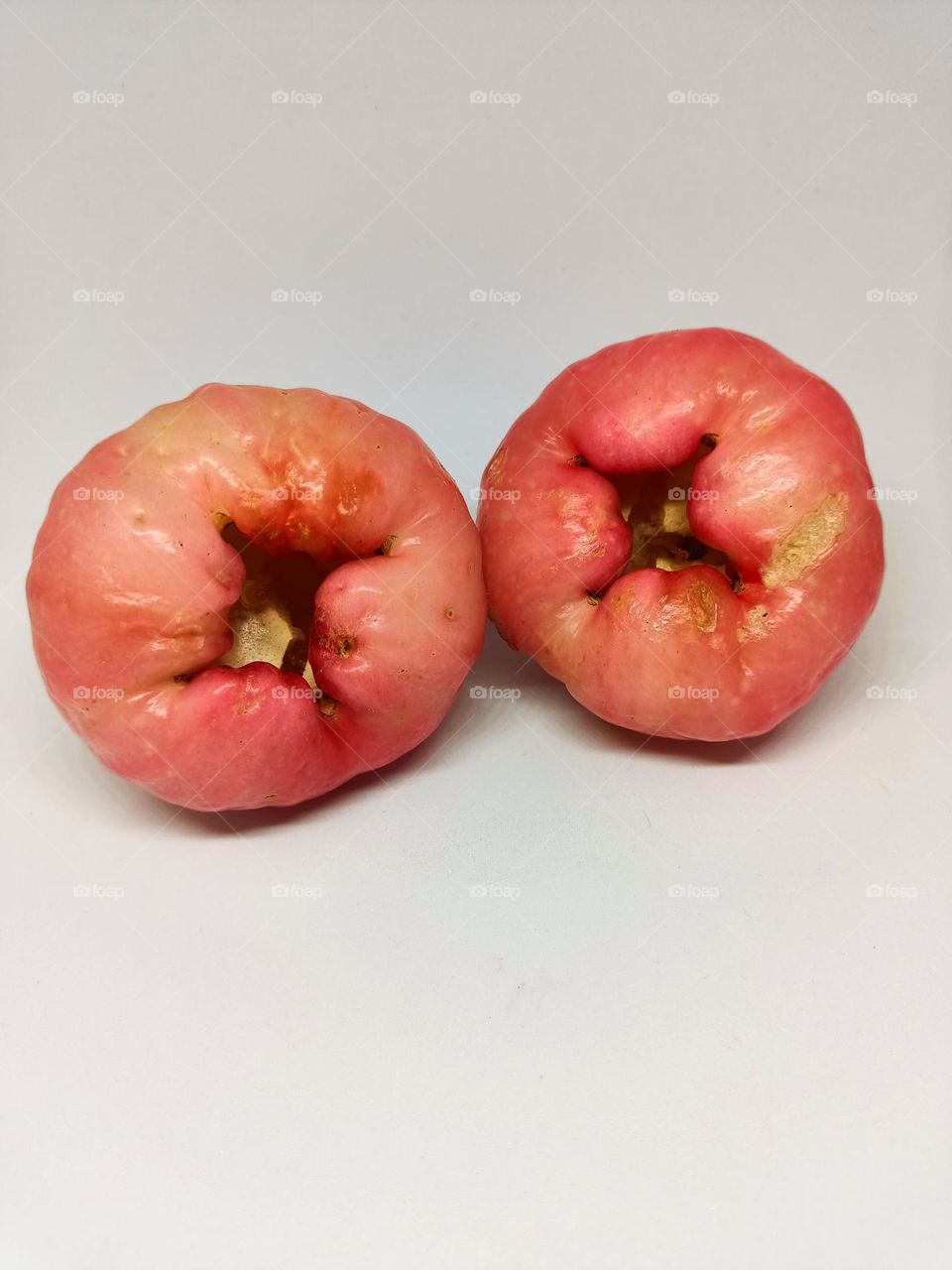Close up of wax apple isolated on white background. Selective focus, underexposed, blurry, low light, too soft