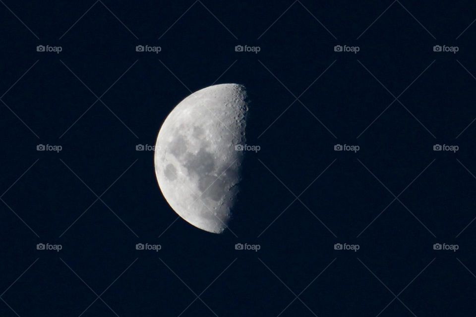 A half moon photograph as it starts to get fuller towards full moon