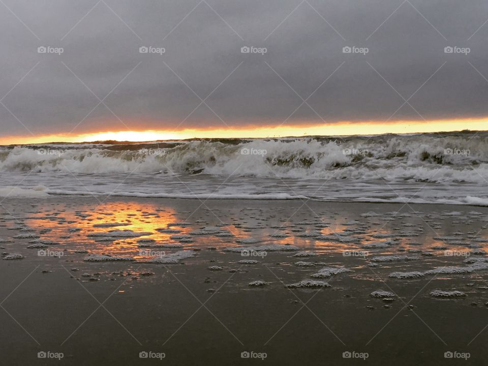 Sunrise over ocean waves. 