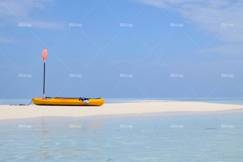 Canoe resting on sandbar in pristine waters