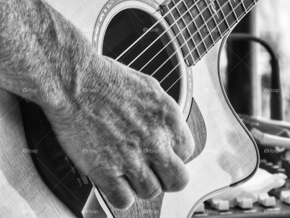 Fingers Plucking An Acoustic Guitar
