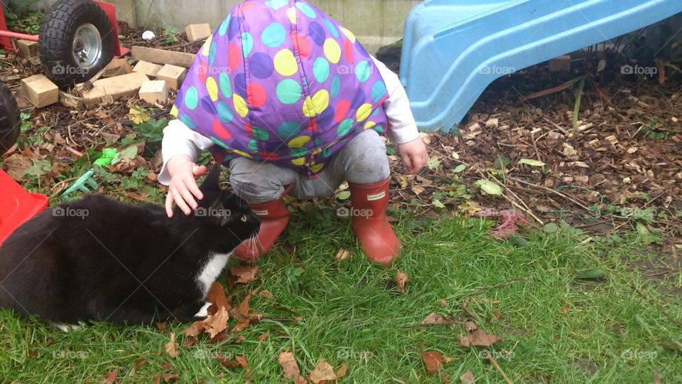 Toddler and black cat