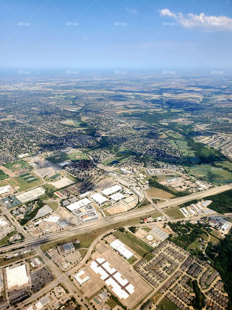 Clouds make for interesting shadows on the ground while on final approach in Dallas Texas