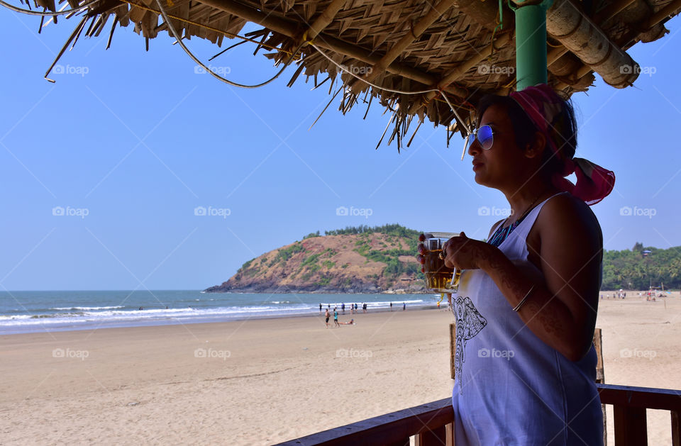 relaxing relaxation in the seaside gokarna beach resort having beer