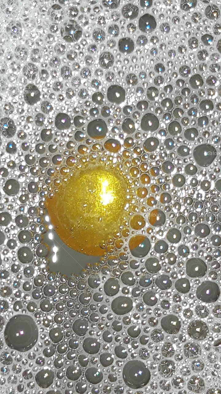 bubble white foam with light yellow shiny floating ball with soapy scent