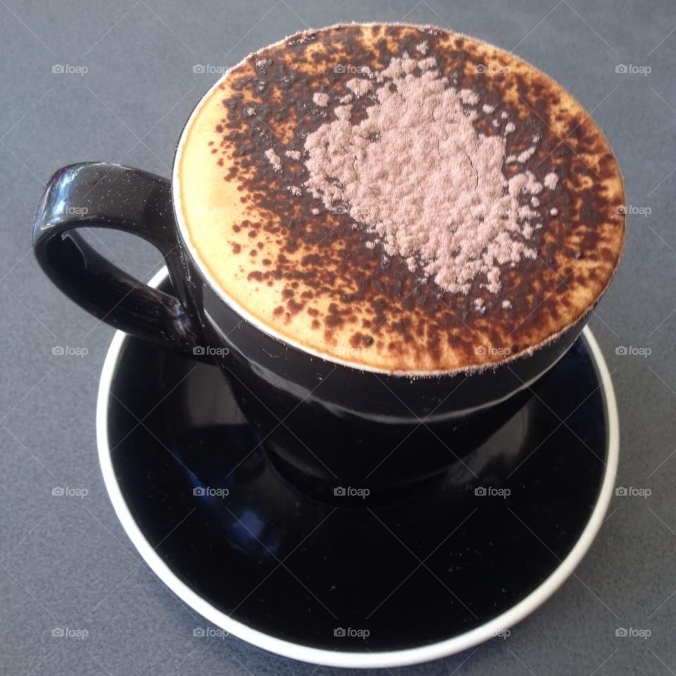 Cappuccino in a black mug