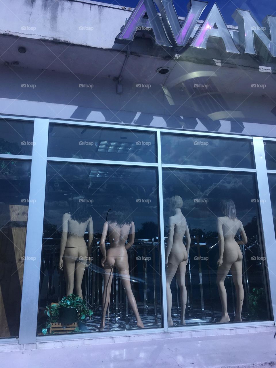 Mannequins in a abandoned store window 