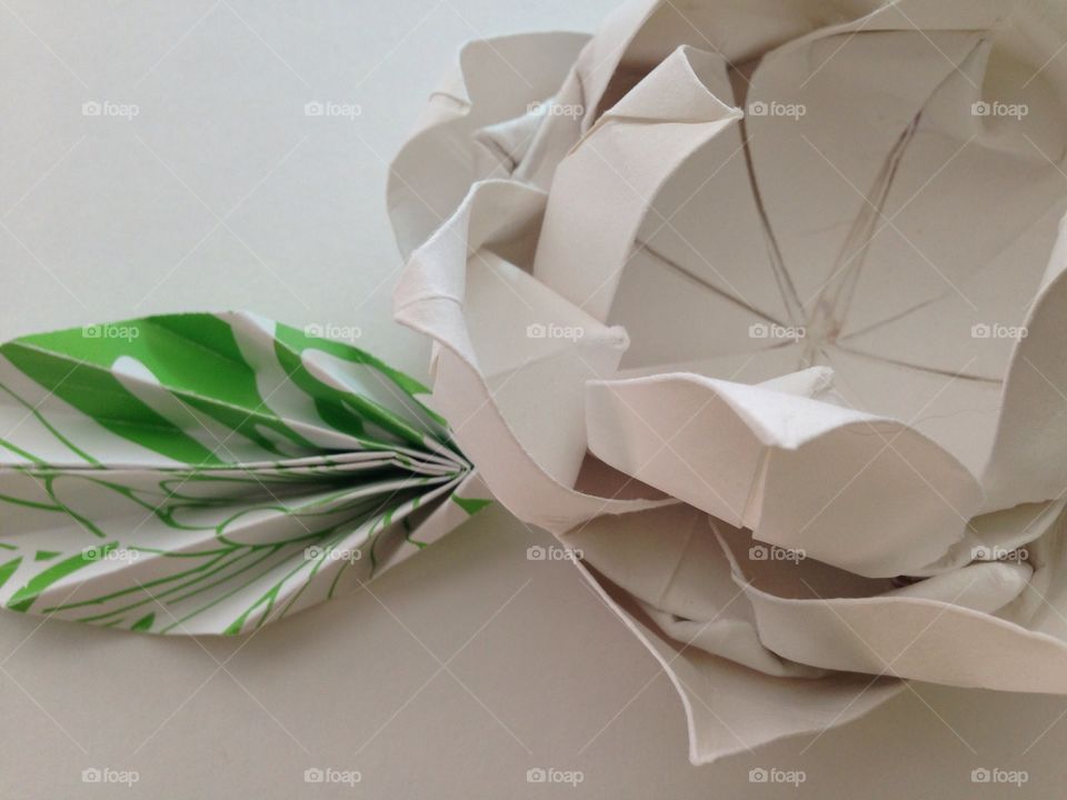 Origami in bloom . White origami flower with leaf